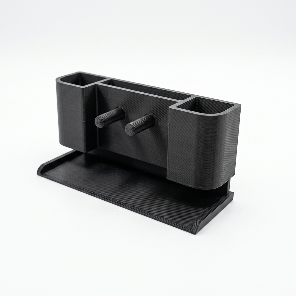 Black desk organizer with multiple compartments on a white background