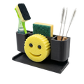 Cleaning utensils including a smiley face sponge, scrubber, and brushes in a black holder on a white background.
