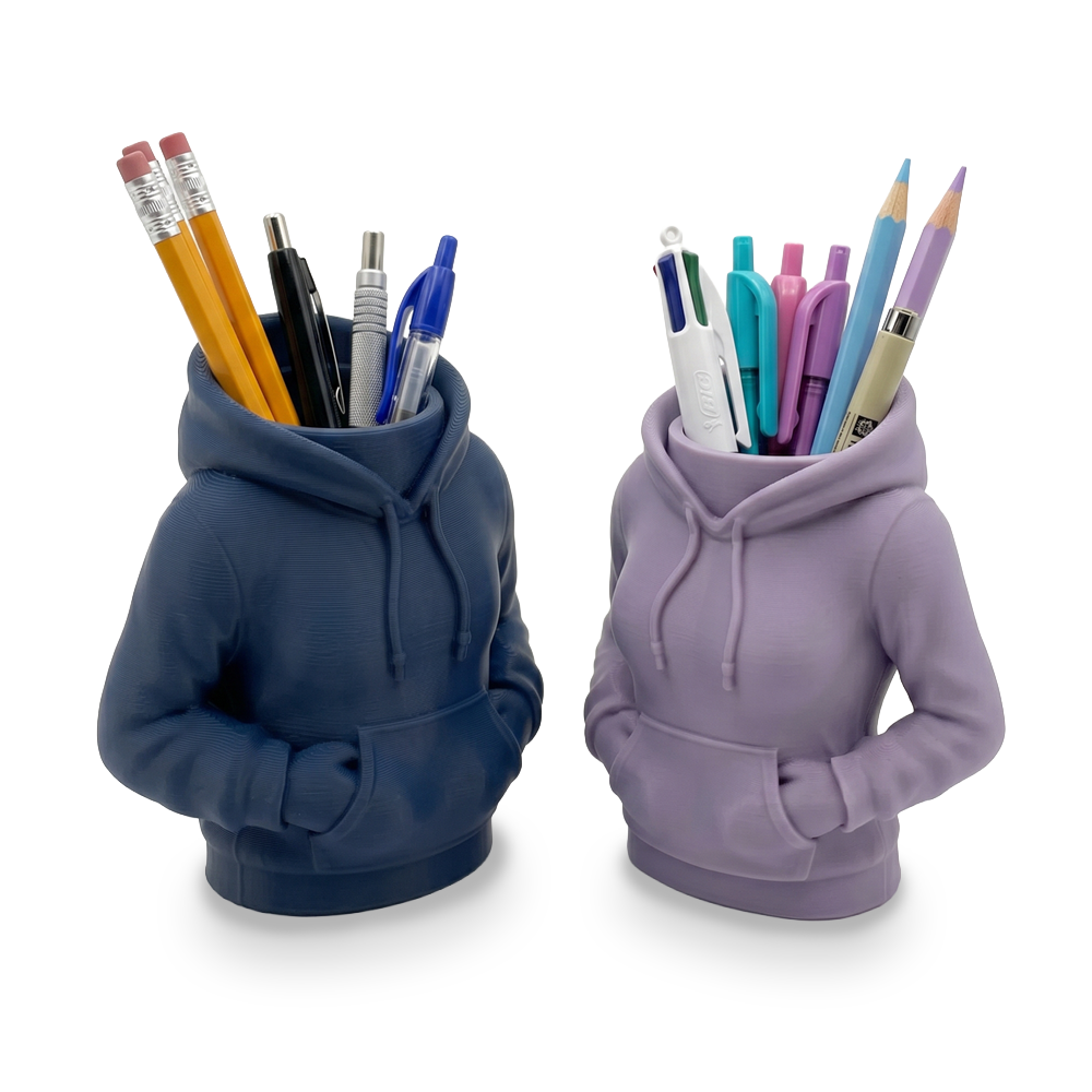 Two hoodie-shaped pencil holders, one blue and one purple, filled with pens and pencils on a white background.